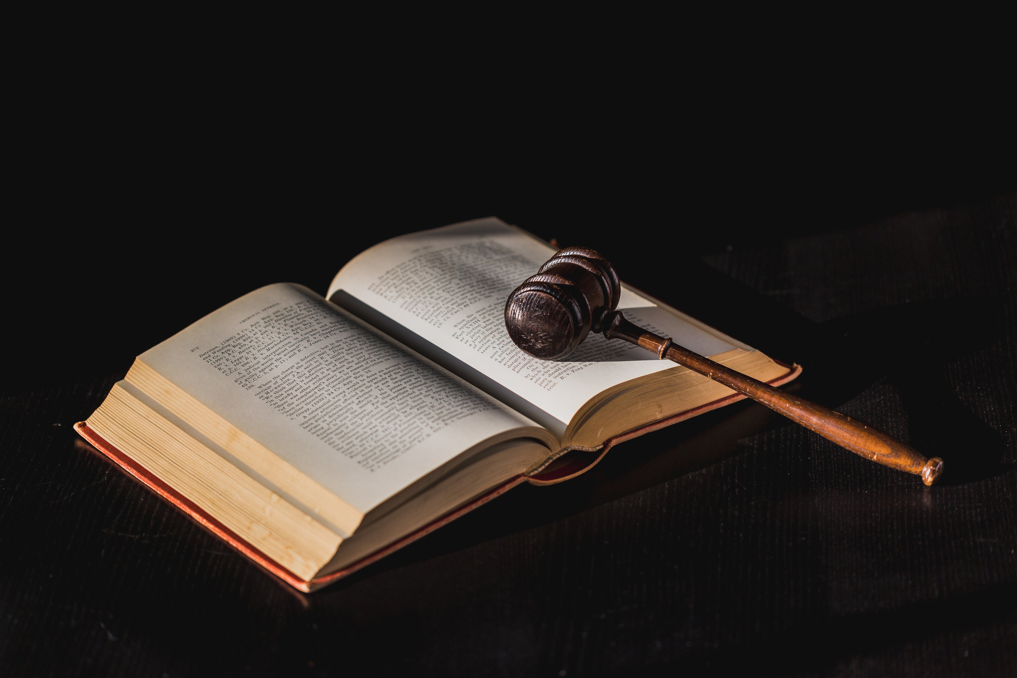 A judges gavel rests on an open law book