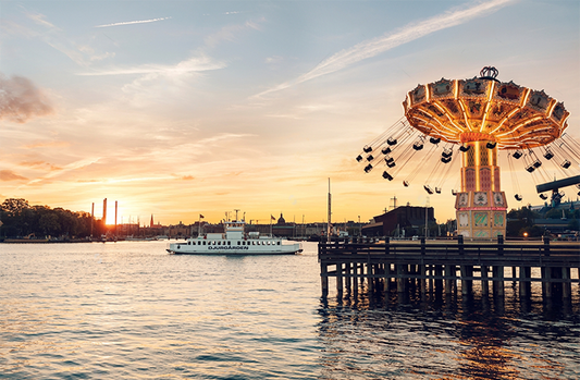 Swinger cruise anchored off illuminated amusement park at sea