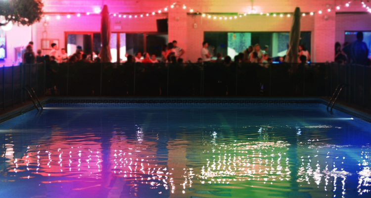 Swingers in a party next to the swimming pool of a hotel.