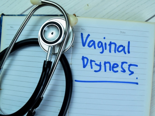 Vaginal Dryness written on white lined pad beside a stethoscope